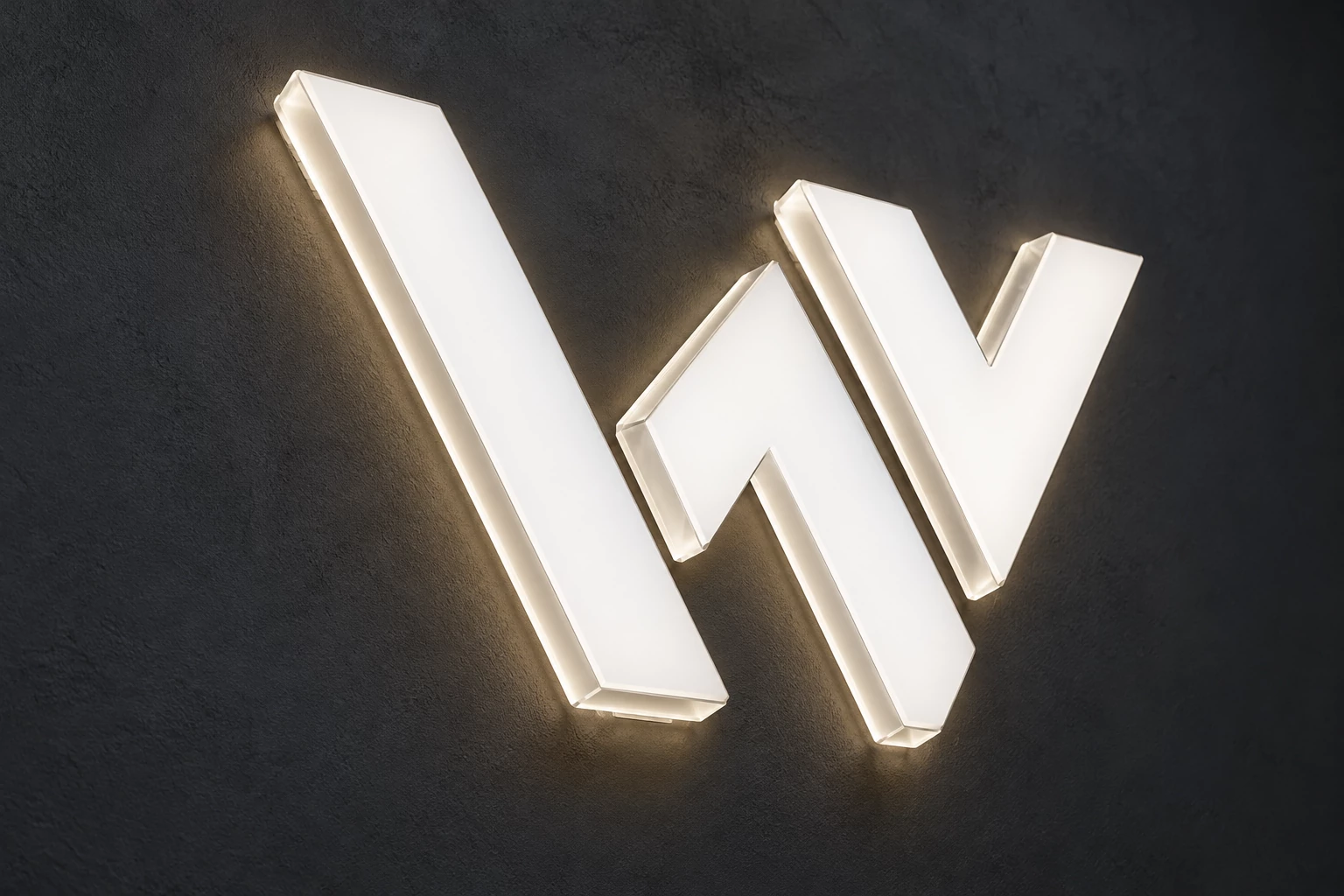 Custom geometric acrylic logo with white illuminated faces and glowing edges on a dark wall