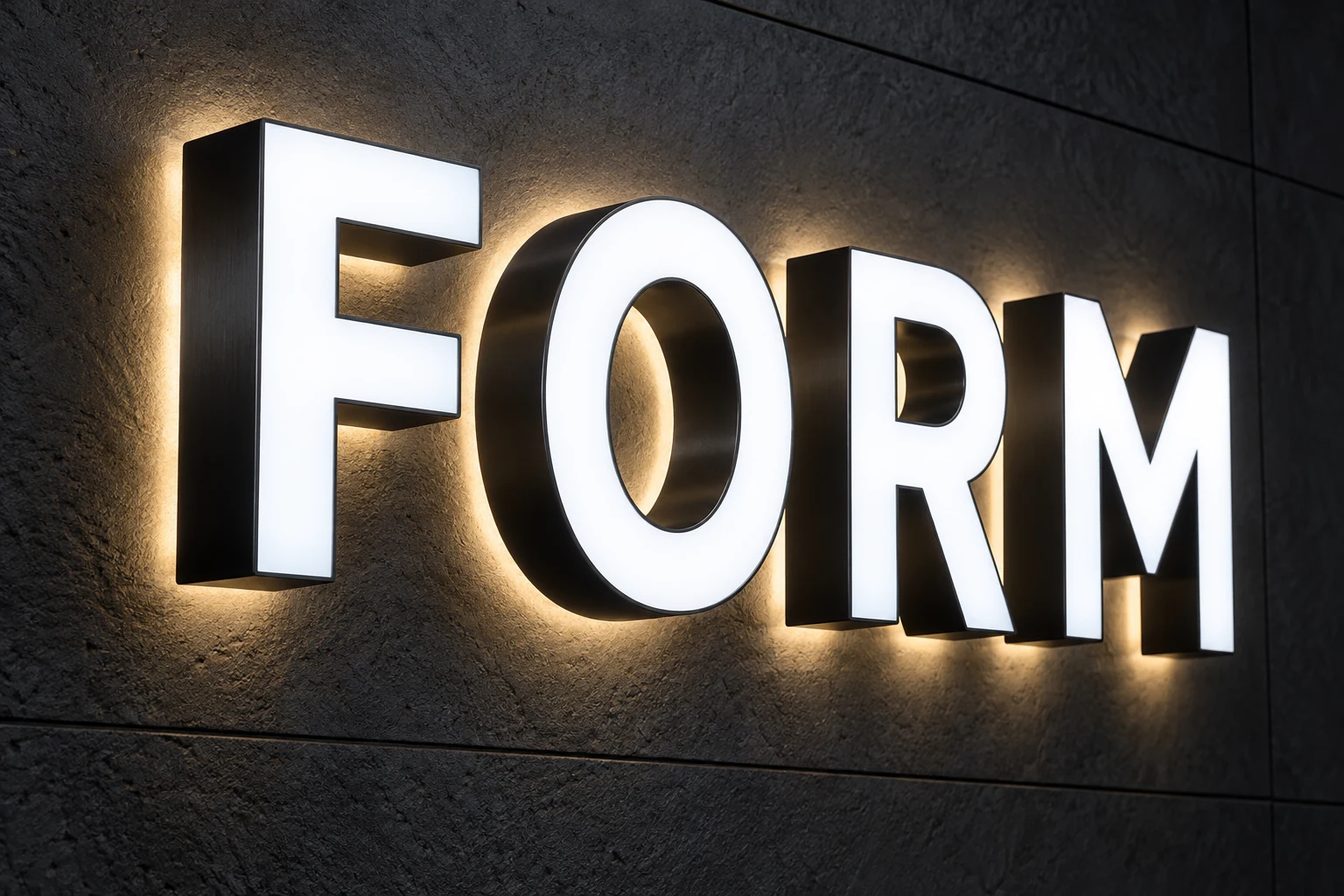 Front and back-lit FORM letters combining illuminated white faces, opaque dark sides and warm wall halos