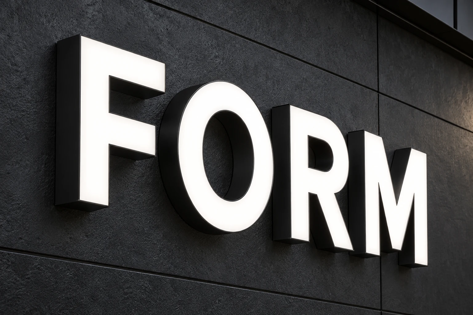 Front-lit FORM channel letters with illuminated white faces and opaque dark metal sides